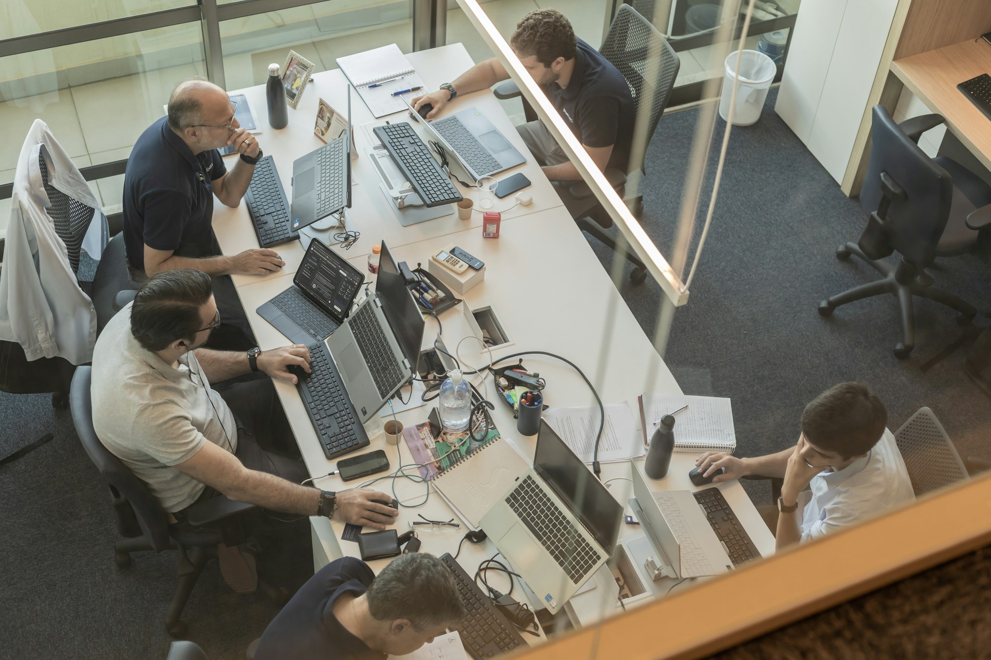 Program team coordinating work in a modern office